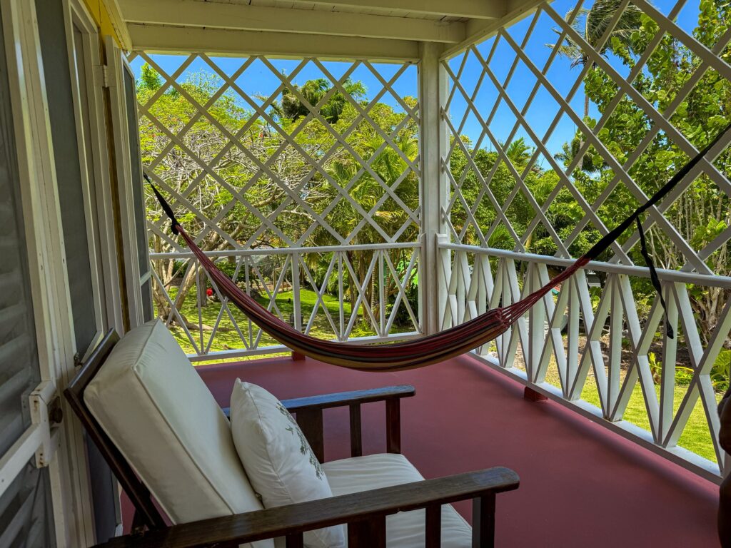 Covered veranda of a Hillside Room with hammock and garden views