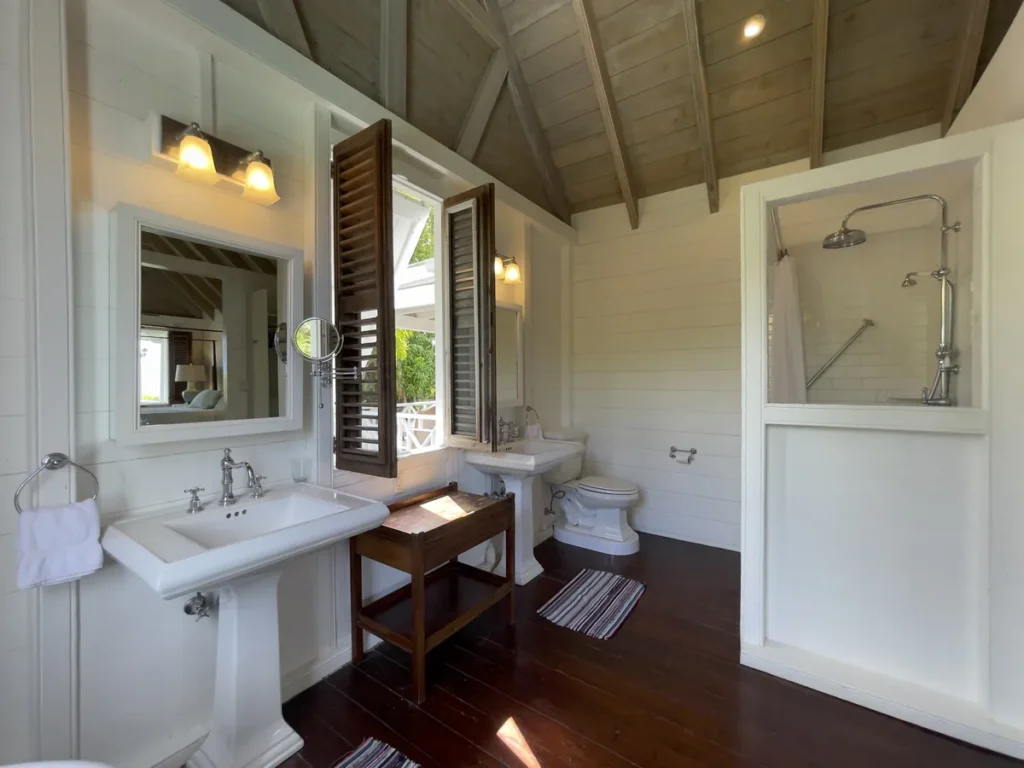 Bathroom at Rose Villa with a pedestal basin, walk-in shower and open timber roof