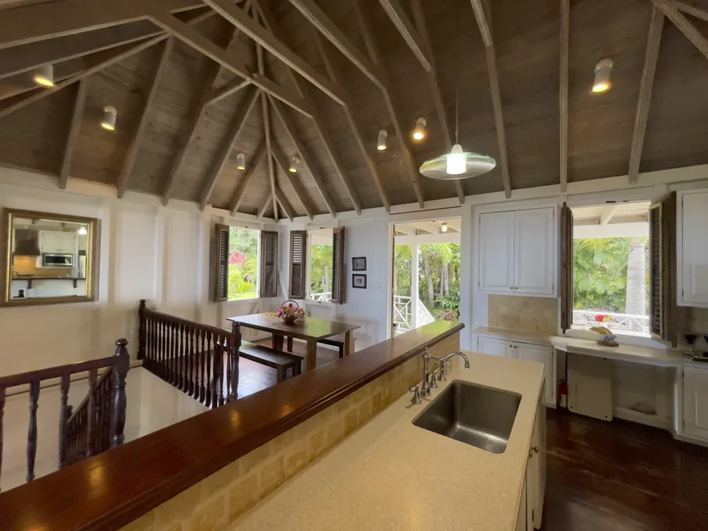 Kitchen at Rose Villa with a breakfast bar looking through to the dining table