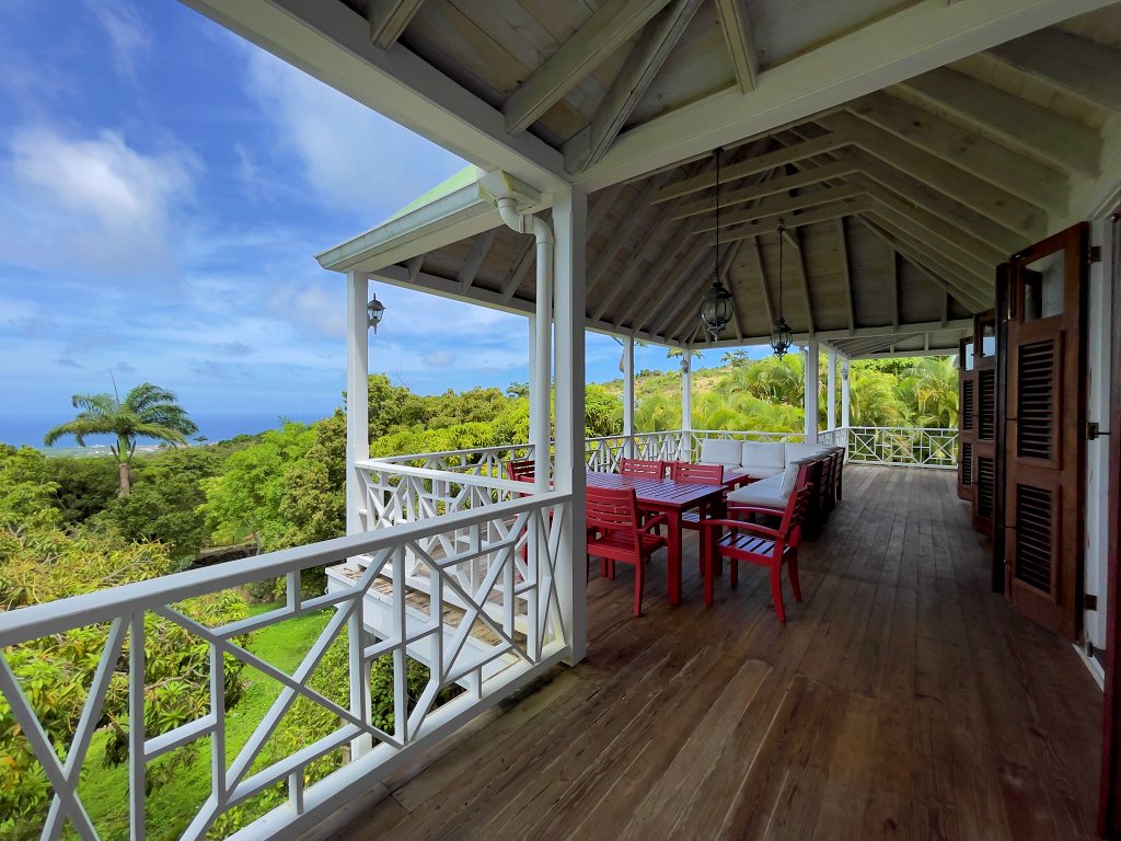 Upstairs porch of Rose Villa with dining table and sea view