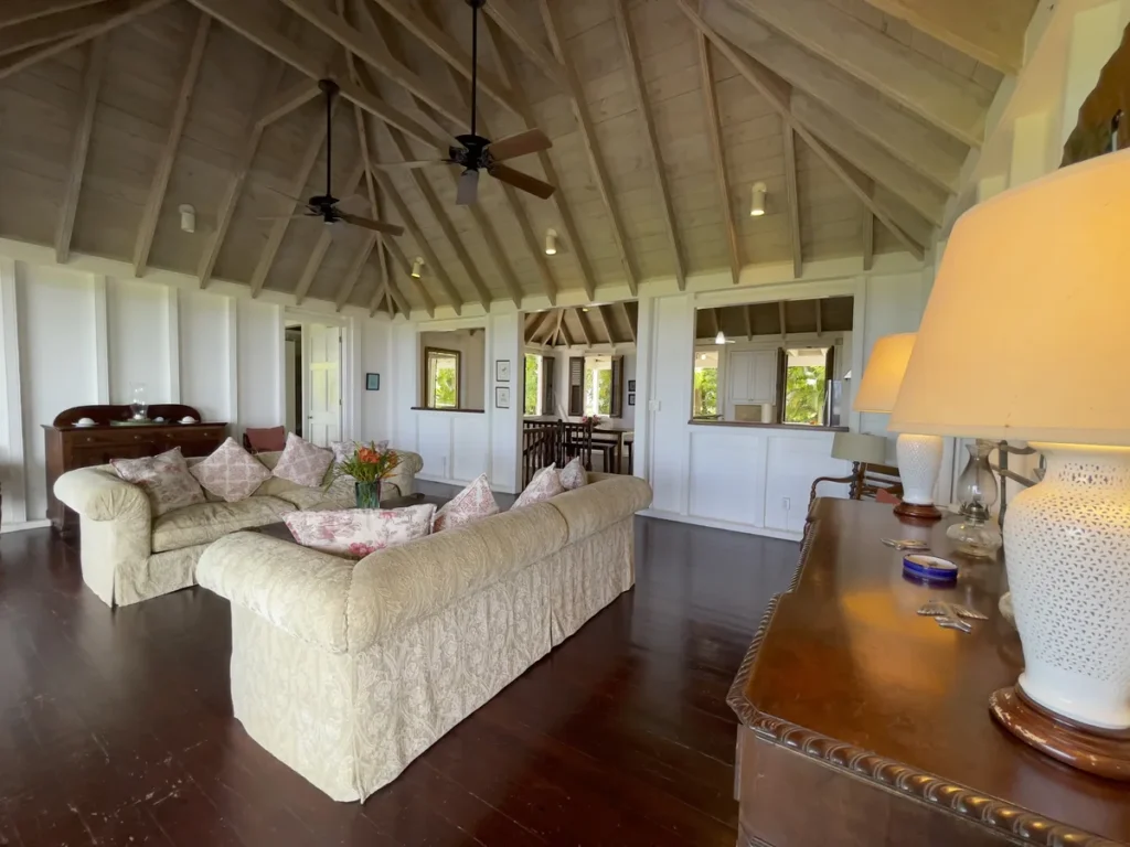Sitting room at Rose Villa with sofas beneath an open timber roof