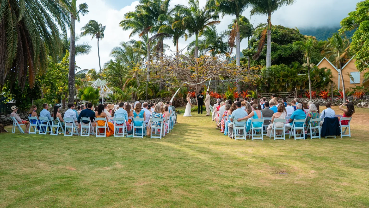 Wide view of an outdoor wedding ceremony in the grounds of Hermitage Nevis
