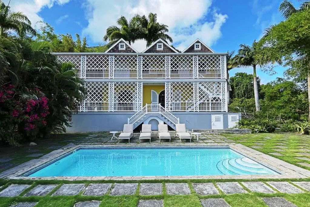 Yellow Manor House with its double staircase, latticed verandas and private pool