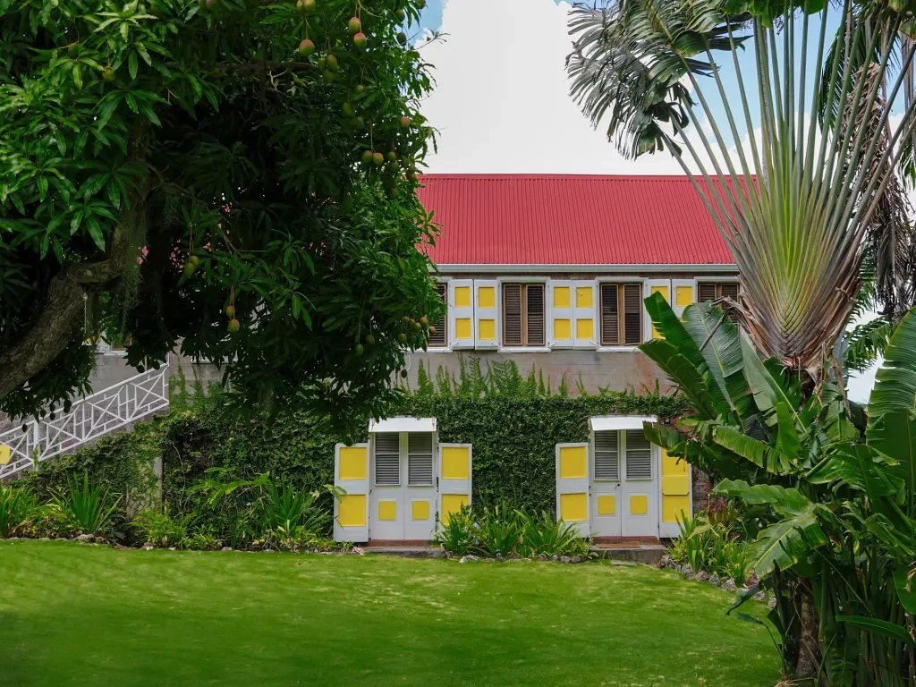 Historic stone building with a red roof, home to two of the four Hillside Rooms