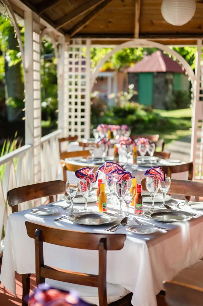 A table laid with madras napkins and glassware in the garden gazebo at Hermitage Nevis